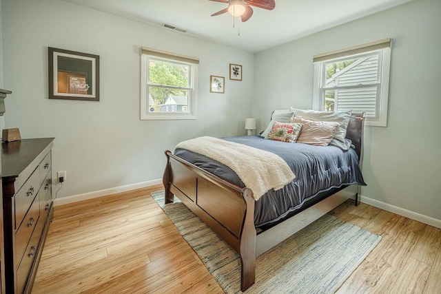 106 Leon St, Madison, WI 53714 - bedroom with multiple windows, light wood finished floors, and baseboards