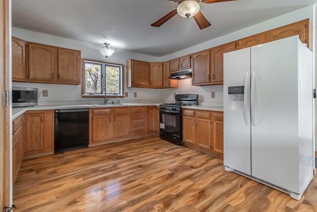 N10368 Queens Way Way, Necedah, WI 54646 - kitchen with a ceiling fan, black appliances, under cabinet range hood, a sink, and light wood finished floors