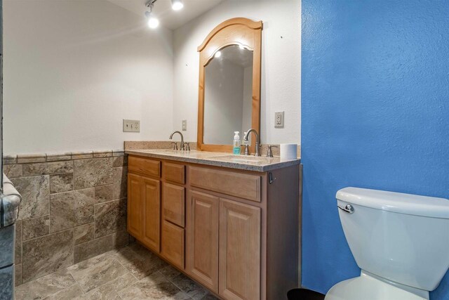 N10368 Queens Way Way, Necedah, WI 54646 - full bath featuring toilet, double vanity, a sink, and tile walls