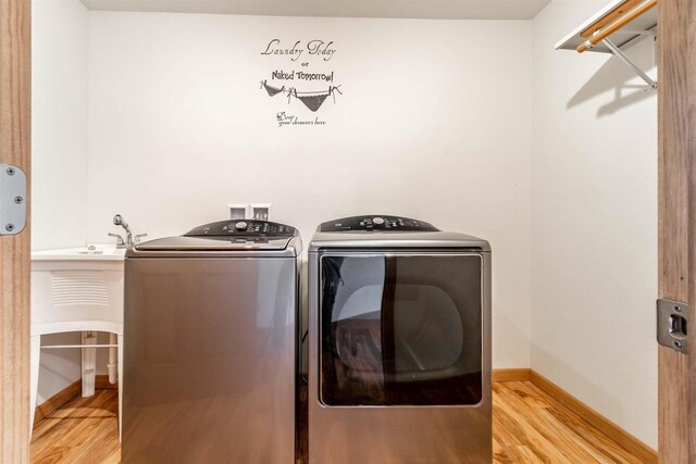 N10368 Queens Way Way, Necedah, WI 54646 - laundry room featuring baseboards, light wood finished floors, washing machine and dryer, and laundry area