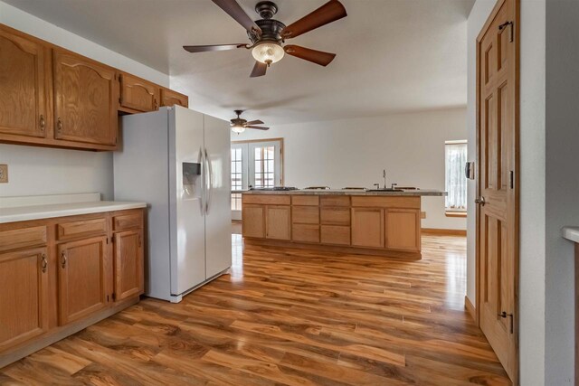 N10368 Queens Way Way, Necedah, WI 54646 - kitchen featuring light countertops, white refrigerator with ice dispenser, ceiling fan, a sink, and wood finished floors
