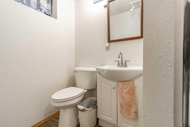 N10368 Queens Way Way, Necedah, WI 54646 - half bathroom with vanity, baseboards, and toilet