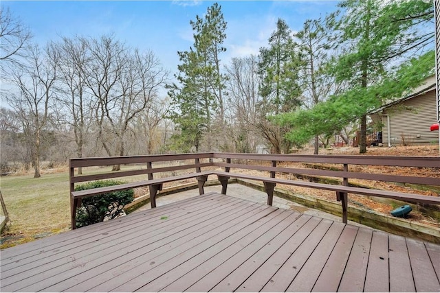 wooden deck featuring a lawn