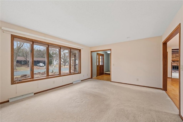 empty room featuring a baseboard radiator, light carpet, visible vents, and baseboards