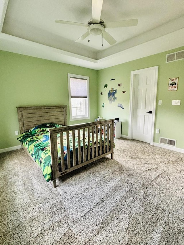 W330S8380 Isabelle Dr, Mukwonago, WI 53149 - carpeted bedroom featuring a tray ceiling, baseboards, and visible vents