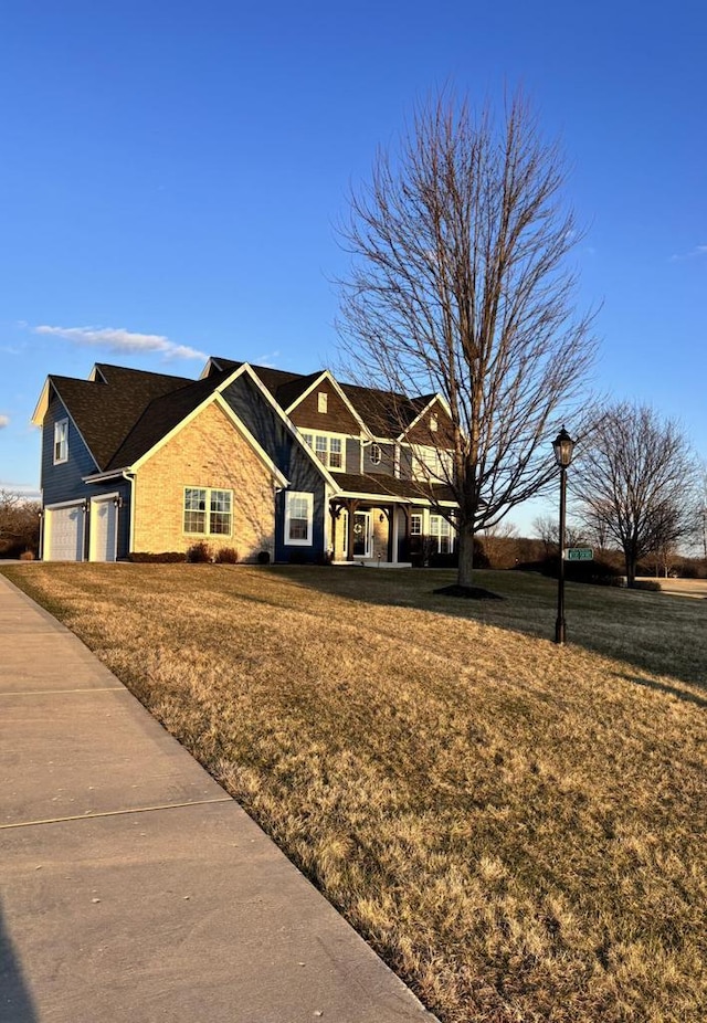 W330S8380 Isabelle Dr, Mukwonago, WI 53149 - view of front of house featuring a garage and a front lawn