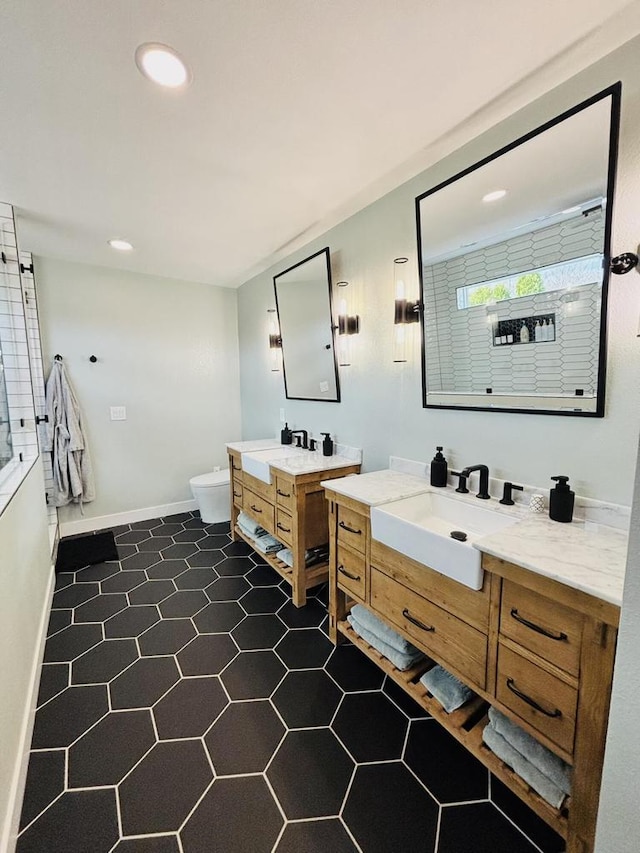 W330S8380 Isabelle Dr, Mukwonago, WI 53149 - full bath featuring two vanities, baseboards, recessed lighting, toilet, and a sink