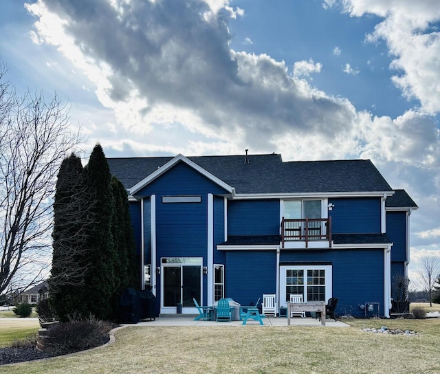 W330S8380 Isabelle Dr, Mukwonago, WI 53149 - back of property featuring a patio area, a shingled roof, a lawn, and a balcony