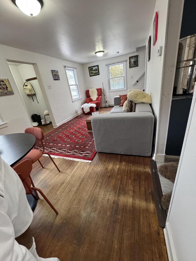 living area with baseboards and hardwood / wood-style floors
