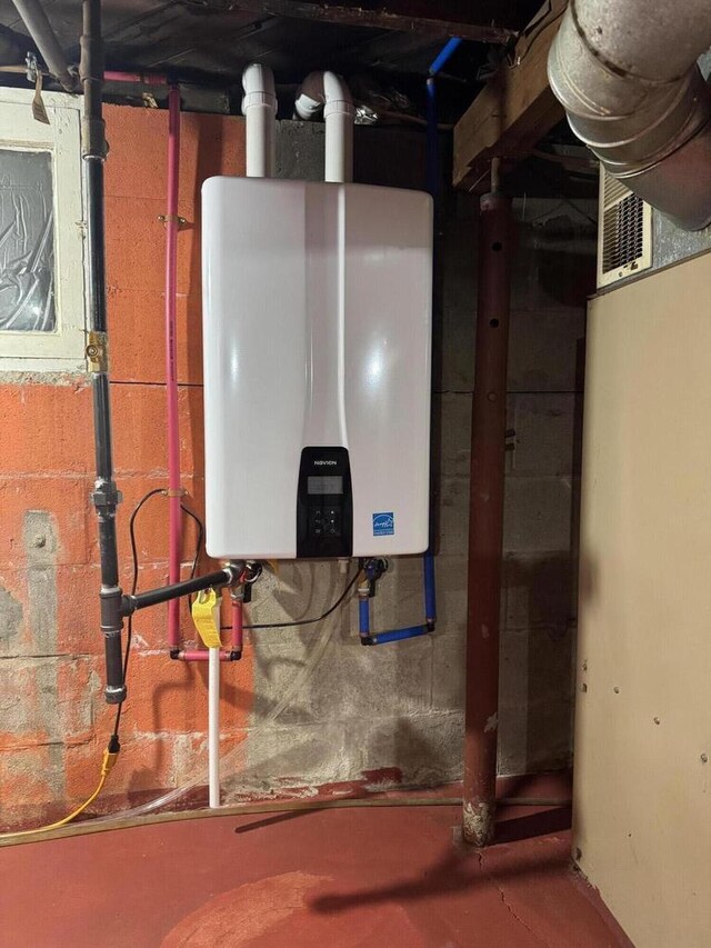 utility room featuring visible vents and water heater