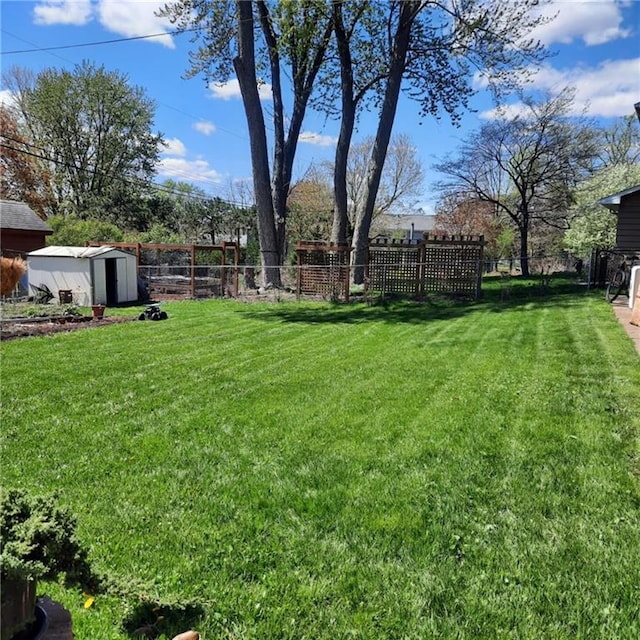 1637 Skeels Ave, Eau Claire, WI 54701 - view of yard featuring a storage shed, an outbuilding, and a fenced backyard