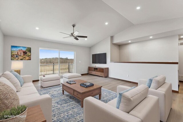 2465 Russell Ct, Reedsburg, WI 53959 - living area featuring light wood-style floors, a ceiling fan, recessed lighting, lofted ceiling, and baseboards