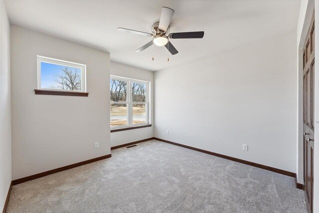 2465 Russell Ct, Reedsburg, WI 53959 - unfurnished bedroom with visible vents, baseboards, ceiling fan, and carpet