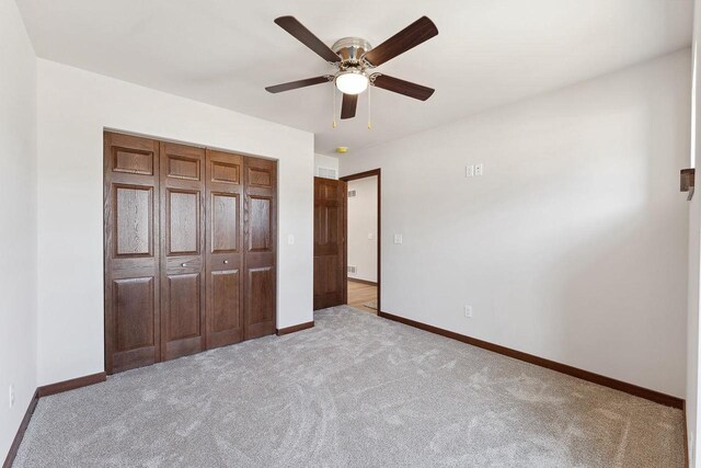 2465 Russell Ct, Reedsburg, WI 53959 - unfurnished bedroom with a closet, carpet flooring, baseboards, and a ceiling fan