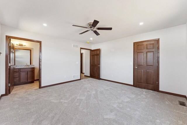 2465 Russell Ct, Reedsburg, WI 53959 - unfurnished bedroom with visible vents, baseboards, and light carpet