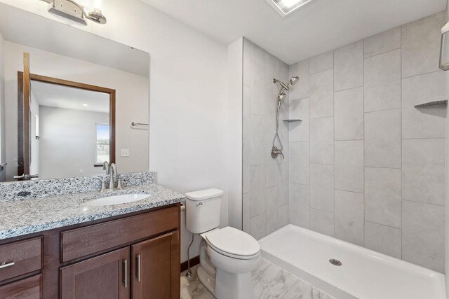 2465 Russell Ct, Reedsburg, WI 53959 - full bathroom with toilet, vanity, a tile shower, and visible vents