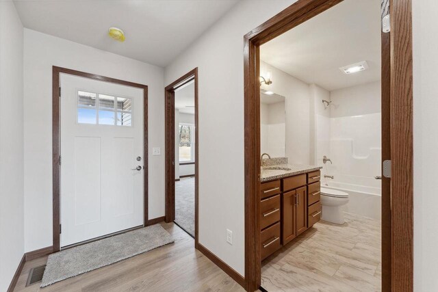 2465 Russell Ct, Reedsburg, WI 53959 - entryway with light wood-style floors, baseboards, and visible vents
