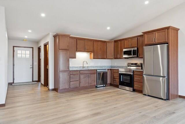 2465 Russell Ct, Reedsburg, WI 53959 - kitchen with recessed lighting, light wood-style flooring, light stone countertops, appliances with stainless steel finishes, and a sink