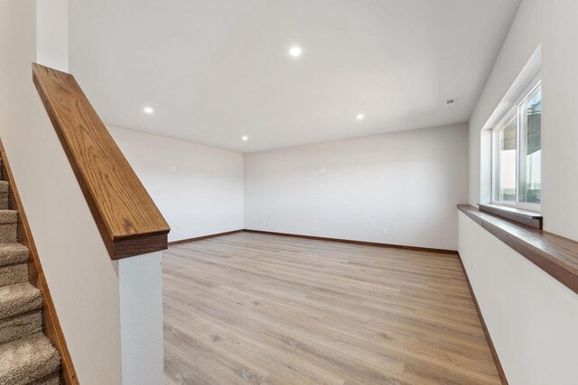 2465 Russell Ct, Reedsburg, WI 53959 - empty room featuring recessed lighting, stairs, light wood-style flooring, and baseboards