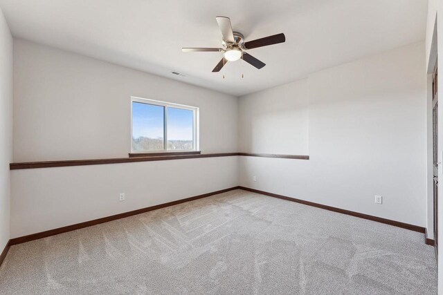 2465 Russell Ct, Reedsburg, WI 53959 - empty room with carpet flooring, baseboards, a ceiling fan, and visible vents