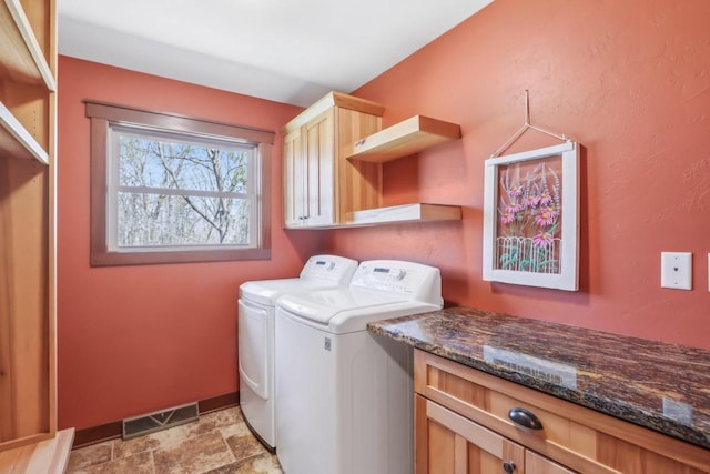 N3759 Airport Rd, Cambridge, WI 53523 - laundry area featuring separate washer and dryer, stone finish floor, visible vents, baseboards, and cabinet space
