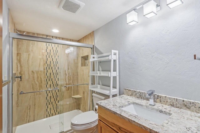 N3759 Airport Rd, Cambridge, WI 53523 - full bath featuring visible vents, toilet, a textured wall, a shower stall, and vanity