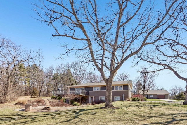 N3759 Airport Rd, Cambridge, WI 53523 - view of front of home with a garage, a wooden deck, and a front lawn