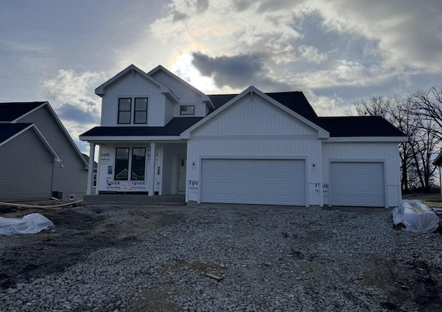 333 Kiddle Ln, Union Grove, WI 53182 - view of front of home featuring an attached garage, board and batten siding, driveway, and covered porch