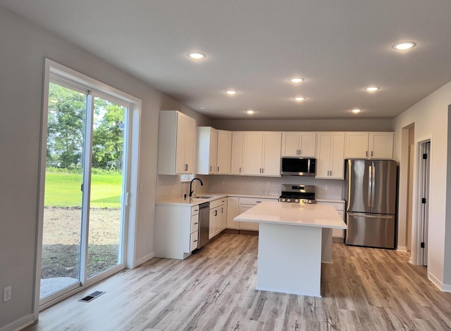 333 Kiddle Ln, Union Grove, WI 53182 - kitchen with stainless steel appliances, light countertops, light wood finished floors, backsplash, and recessed lighting