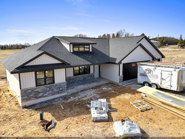 665 Kroll Rd, Pulaski, WI 54162 - modern farmhouse featuring a garage, a shingled roof, and stone siding