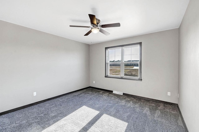 665 Kroll Rd, Pulaski, WI 54162 - empty room with dark carpet, baseboards, and a ceiling fan
