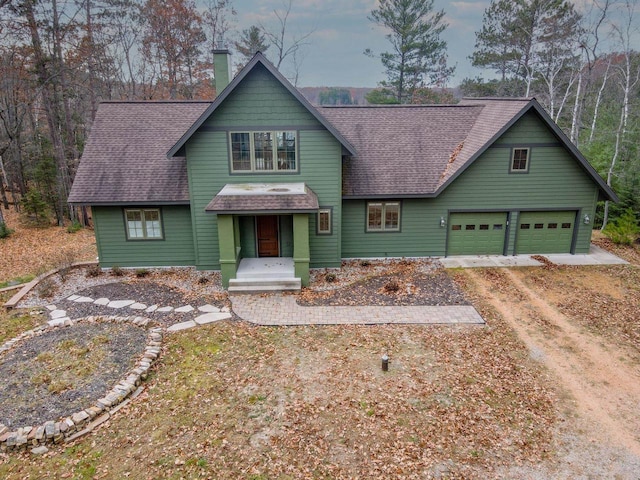 6579 Maple Tree Rd, Crescent, WI 54501 - craftsman-style home featuring a chimney, a shingled roof, a garage, and driveway