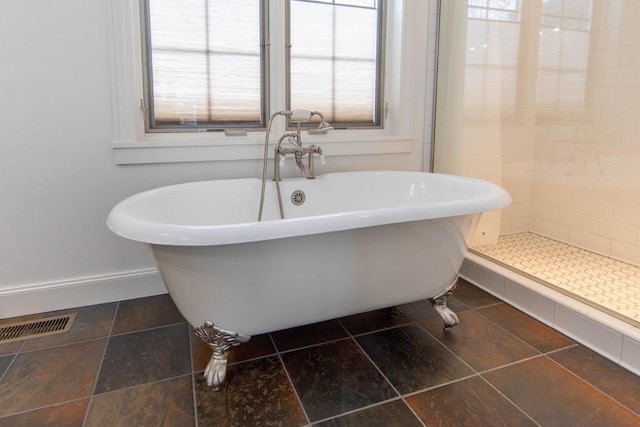 6579 Maple Tree Rd, Crescent, WI 54501 - bathroom featuring a soaking tub, baseboards, visible vents, and tiled shower
