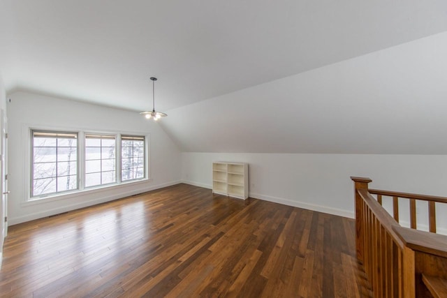 6579 Maple Tree Rd, Crescent, WI 54501 - additional living space with built in features, baseboards, dark wood-style floors, and lofted ceiling