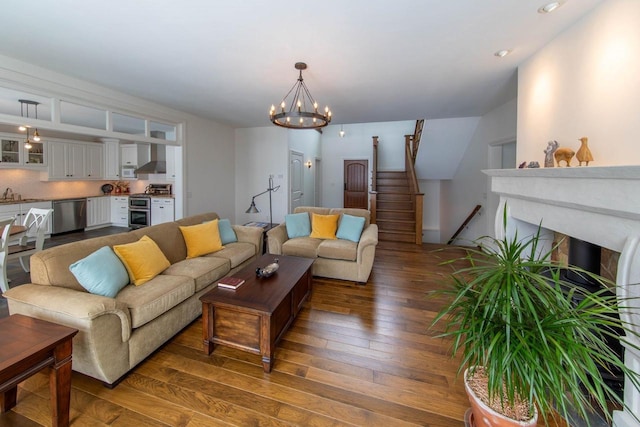 6579 Maple Tree Rd, Crescent, WI 54501 - living room featuring an inviting chandelier, hardwood / wood-style floors, a fireplace, and stairs