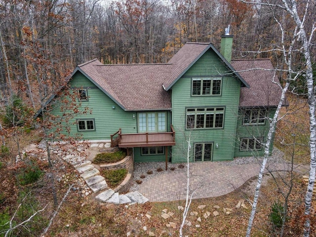6579 Maple Tree Rd, Crescent, WI 54501 - rear view of property featuring a chimney, roof with shingles, a patio, french doors, and a deck