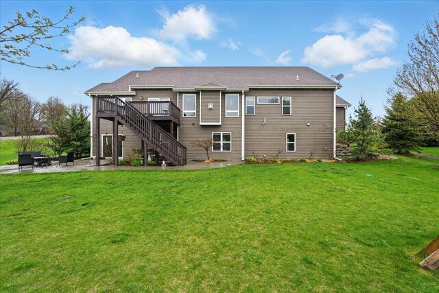 rear view of house featuring a deck, a yard, a patio area, and stairway