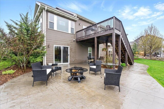 back of house with stairway, a deck, a fire pit, and a patio