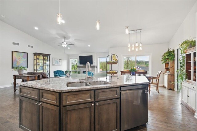 kitchen with a sink, lofted ceiling, dark wood-type flooring, and dishwasher