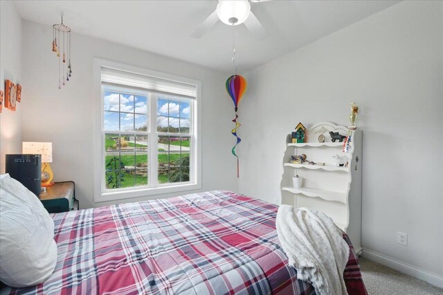 bedroom with baseboards, a ceiling fan, and carpet floors