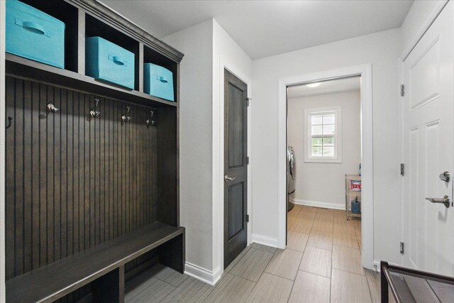 mudroom featuring baseboards and washer / dryer