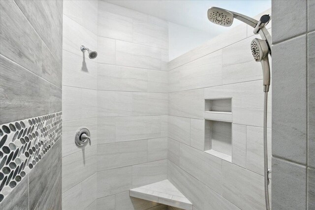 bathroom with a tile shower
