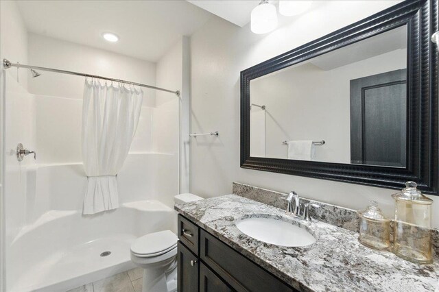 bathroom featuring vanity, tile patterned flooring, toilet, and a shower with shower curtain
