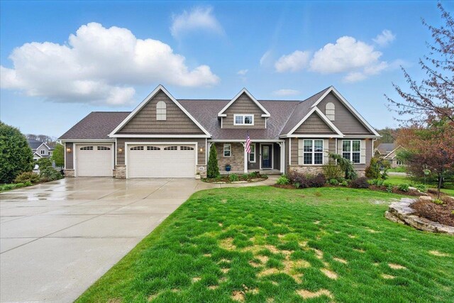 craftsman house featuring an attached garage, a front yard, driveway, and stone siding