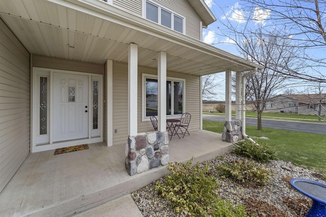 view of exterior entry with covered porch