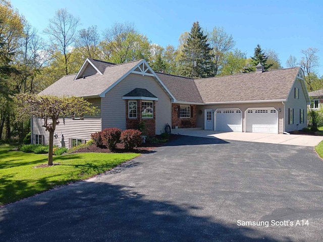 N5120 Summit Ct, Fond Du Lac, WI 54937 - view of front of home featuring a front yard, a shingled roof, driveway, and an attached garage