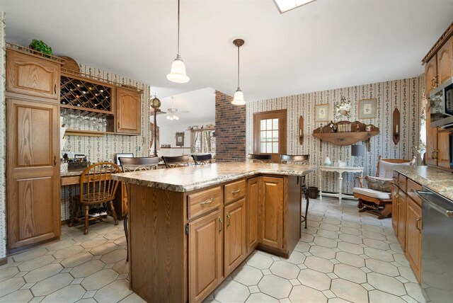 N5120 Summit Ct, Fond Du Lac, WI 54937 - kitchen featuring a center island, decorative light fixtures, ceiling fan, wallpapered walls, and stainless steel dishwasher