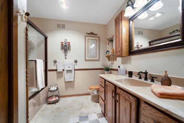 N5120 Summit Ct, Fond Du Lac, WI 54937 - bathroom with combined bath / shower with glass door, vanity, baseboards, toilet, and visible vents