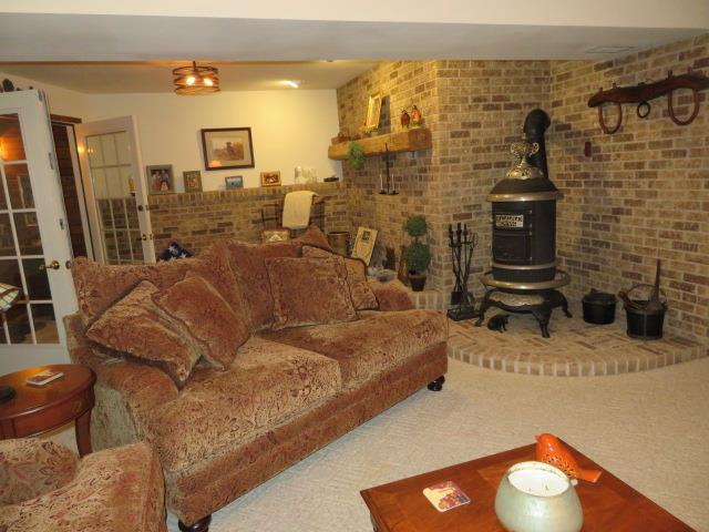 N5120 Summit Ct, Fond Du Lac, WI 54937 - carpeted living room featuring a wood stove
