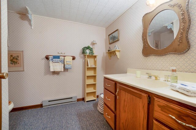 N5120 Summit Ct, Fond Du Lac, WI 54937 - bathroom featuring baseboards, toilet, crown molding, vanity, and a baseboard heating unit